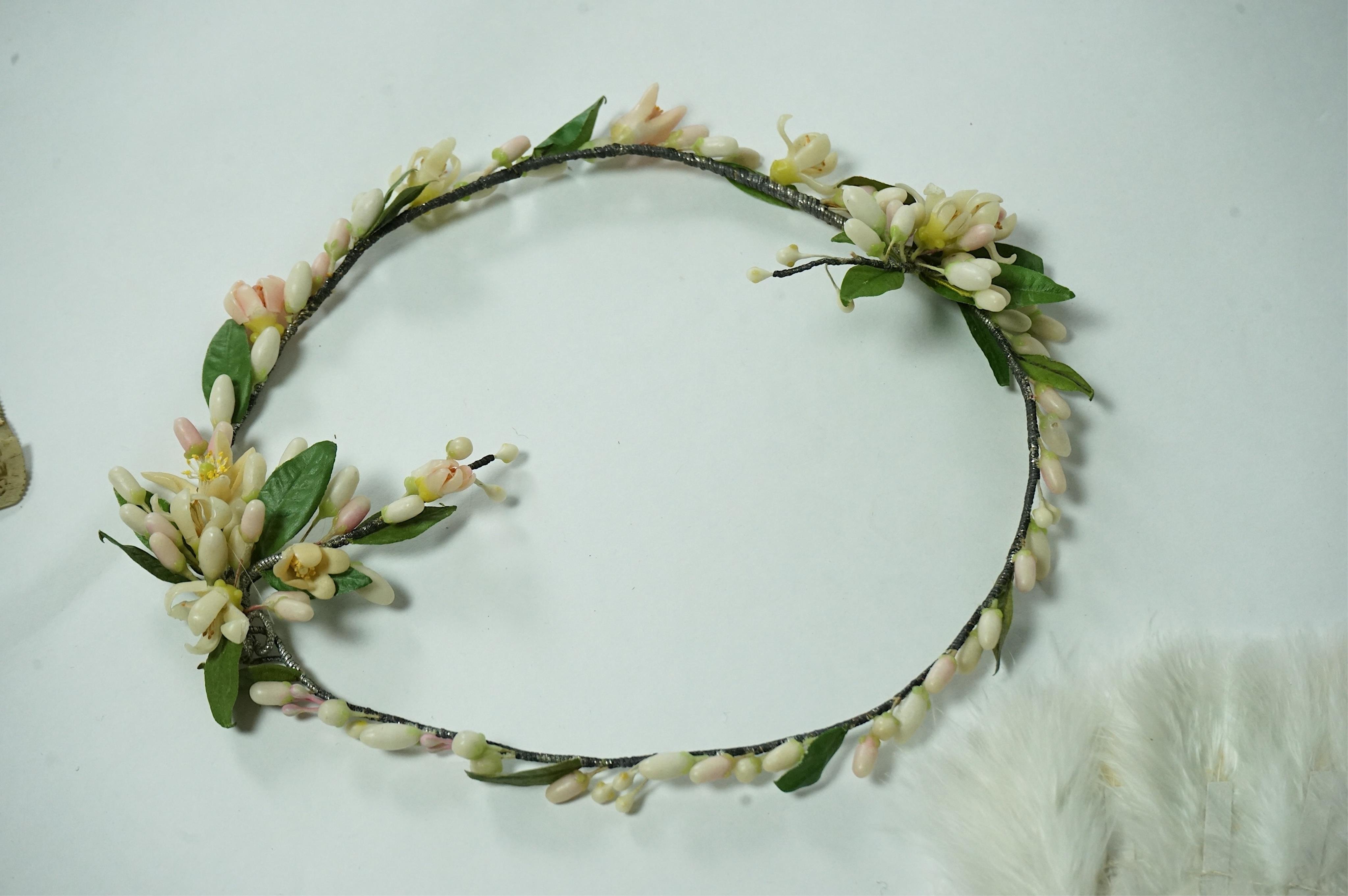 A 1920’s wax wedding headdress, a white feather fan, a bone brise and an earlier long lawn embroidered and lace worked stole., Stole 194cm long. Condition - headdress and fan good, stole has moth holes in places but can